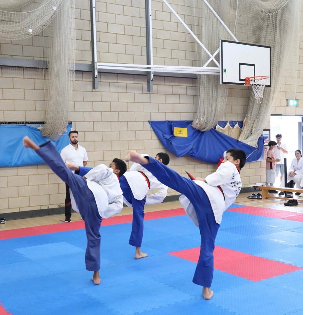 Cadets performing high kicks during a sparring drill