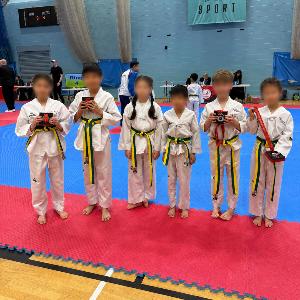 Six students with their medals at a competition